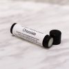 Chocolate lip balm in black tube with lid off