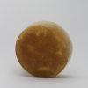 brown colour round soap with a loofah inside approx 1 inch thick by 3 inches across scented in Patchouli