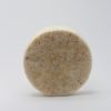 round bar of cream colour soap with ground oatmeal in bar with a loofah inside 1 inch thick by 3 inches across the bar scented in oatmeal milk and honey