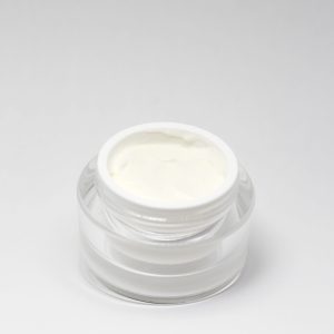 facial moisturizer jar white cream with a white background